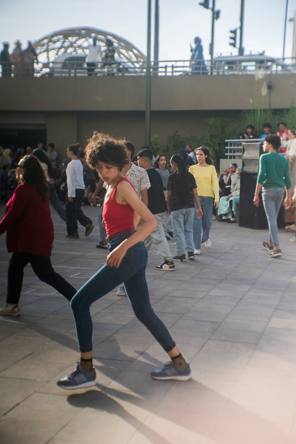 Young performers moving in formation during an outdoor rehearsal